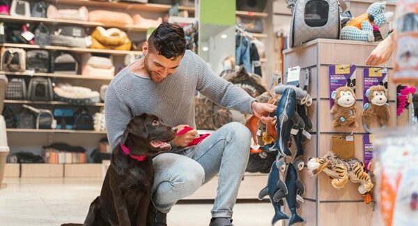 Tiendas de juguetes para perros - Hombre eligiendo un juguete interactivo para perro en una de las mejores tiendas de juguetes para perros en Madrid